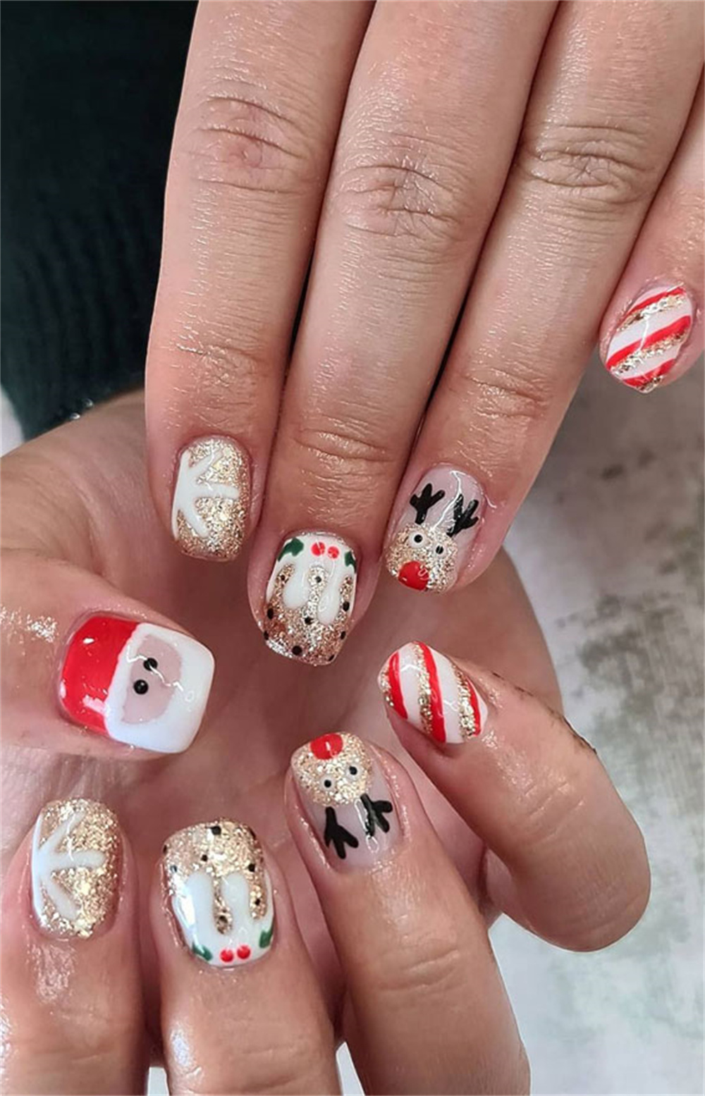 Christmas nails with golden reindeer accents